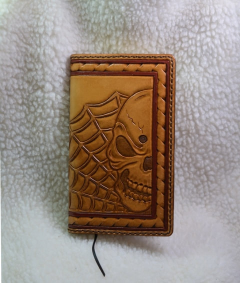 Leather journal cover with carved skull and web design medium brown color