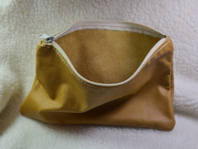 Tan leather zipper pouch approximately 7 inches by 10 inches. Open view.