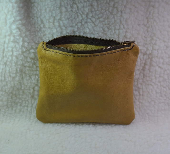Tan leather zipper pouch approximately 5-1/4 inches by 6 inches. Open view.